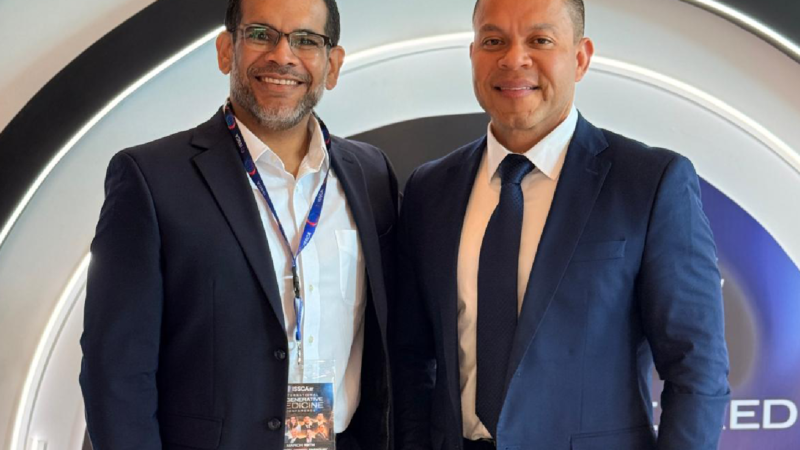 Dr. Christopher Walker at a regenerative medicine conference with a colleague, discussing advancements in regenerative healing and stem cell therapy