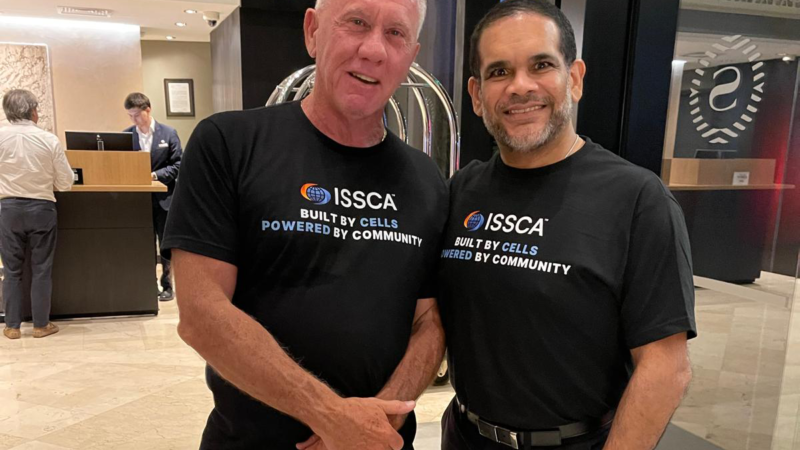 Dr. Christopher Walker with a colleague at an ISSCA event promoting global regenerative medicine training and collaboration