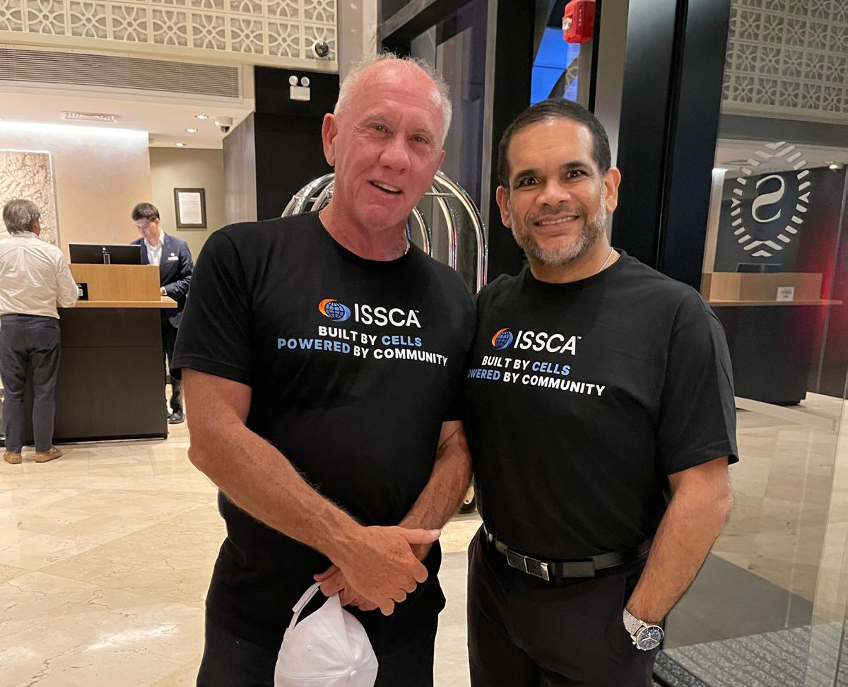 Dr. Christopher Walker with a colleague at an ISSCA event promoting global regenerative medicine training and collaboration