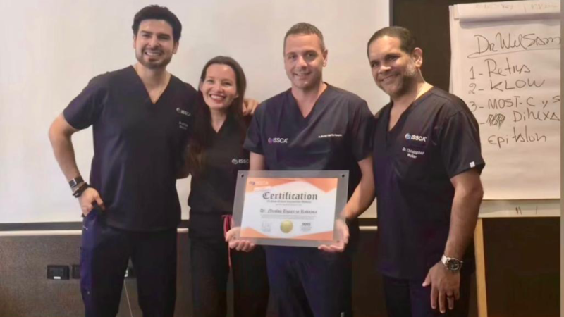 Dr. Christopher Walker with medical professionals holding ISSCA certification during regenerative medicine workshop training session