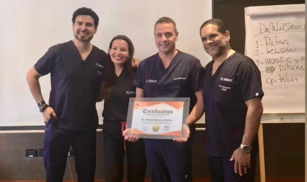 Dr. Christopher Walker with medical professionals holding ISSCA certification during regenerative medicine workshop training session